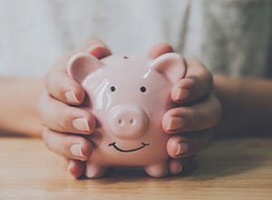 Individual holding a piggy bank