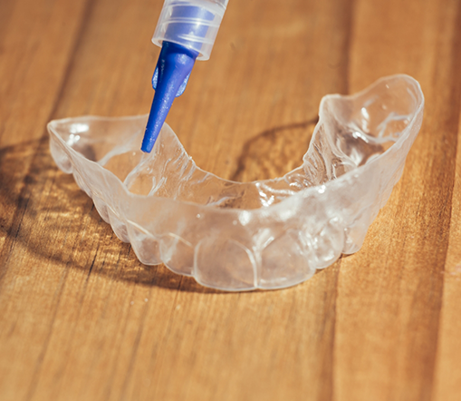 Whitening tray on wooden table about to be filled