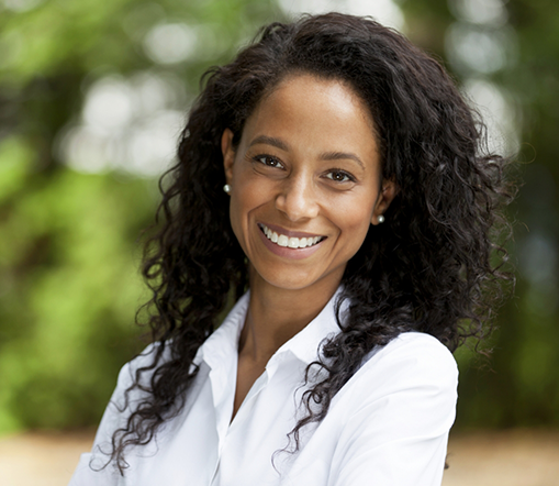 Woman in white shirt standing and smiling