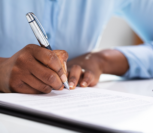 Man with pen filling out some forms