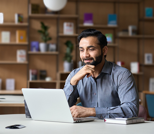 Bearded man looking at a laptop