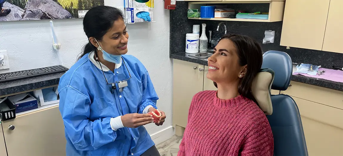 Dr. Shevy talking to patient in red sweater