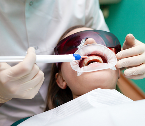 Female patient receiving teeth whitening in West Palm Beach