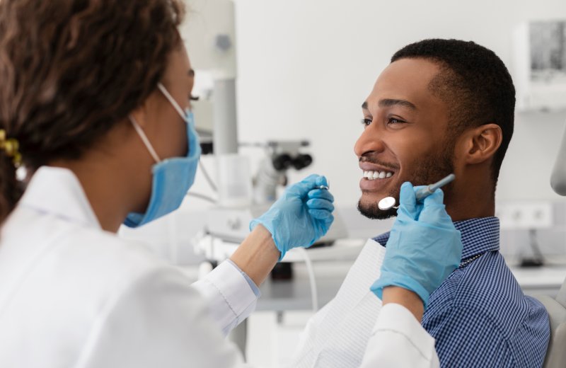 Patient smiling at hygienist at dental cleaning